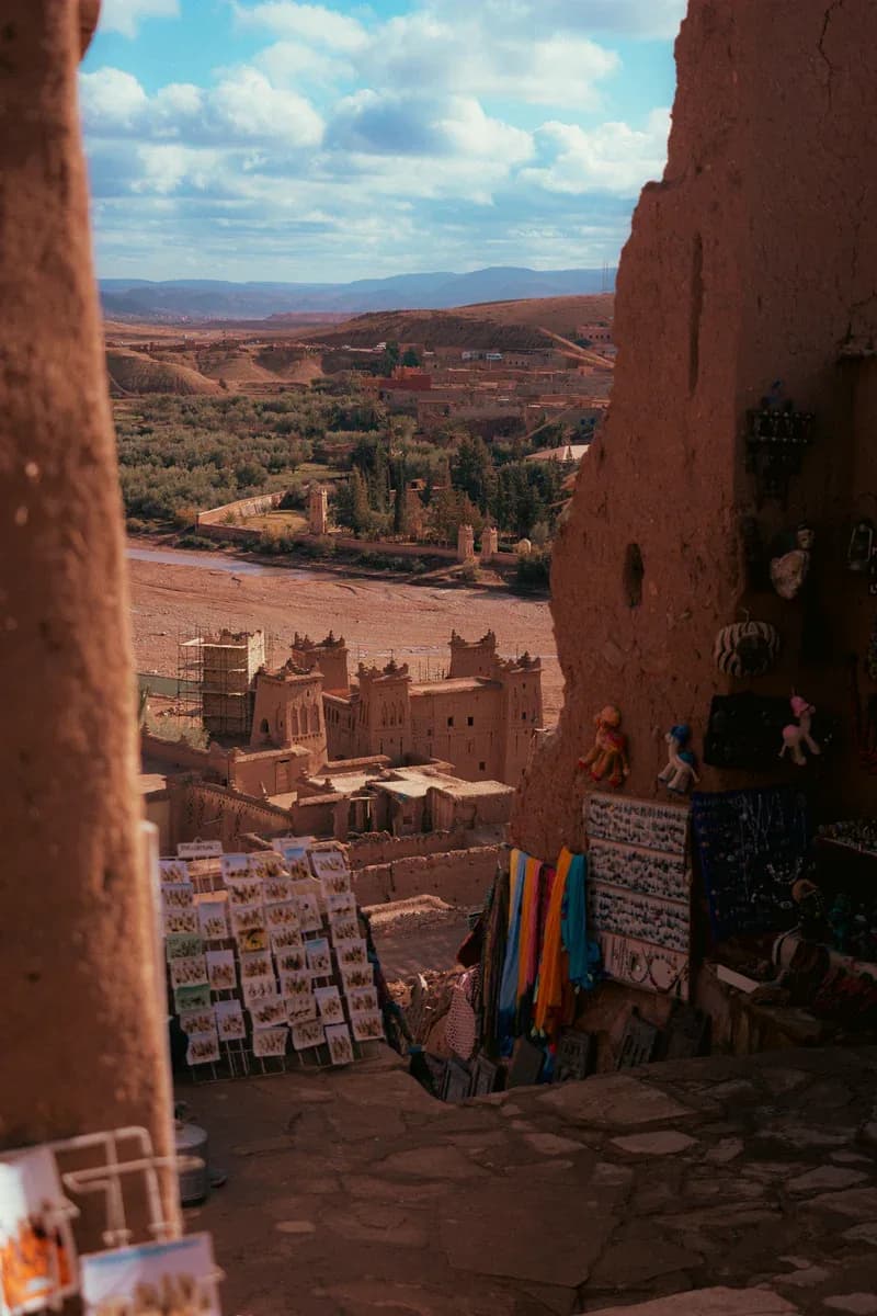 Looking down from the alleys of Aït Ben Haddou over the valley, souvenirs hung on the earthen walls
