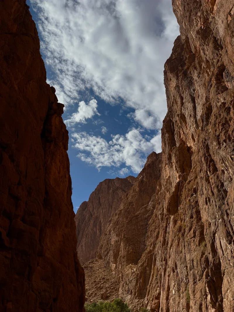 Looking up between the cliffs of the Todra Gorge to a cloudy sky